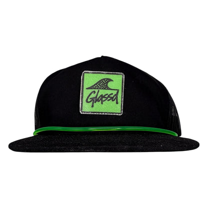 The Foam, black GLASSD hat with handmade fiberglass patch and green surfboard leash over the bill