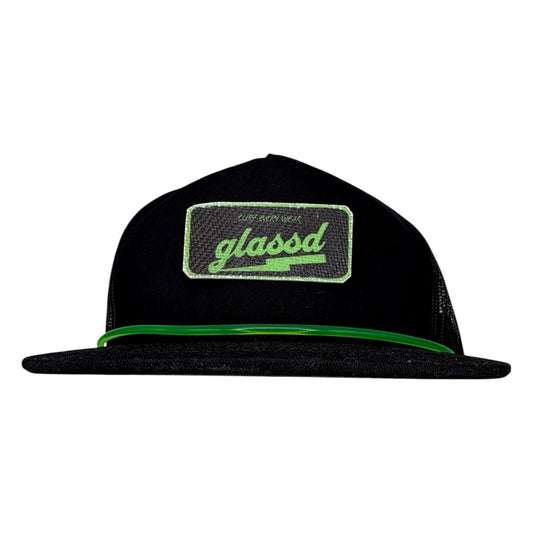 The Rail, black GLASSD hat with handmade fiberglass patch and green surfboard leash over the bill